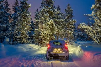 Car traveling on a snowy road.