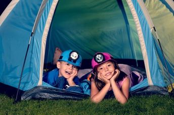 Kids camping in their backyard.