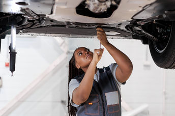 A female car mechanic at work.