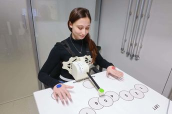 Researcher testing the robotic arm.