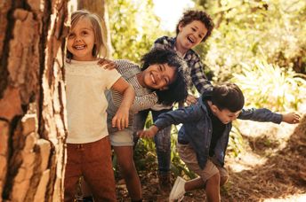 Children playing outside in nature.