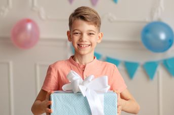 Cute boy bearing a gift.