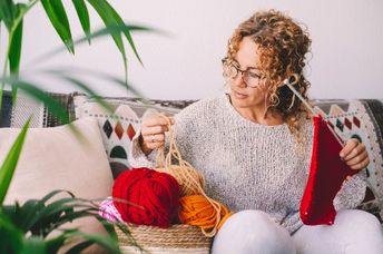 Woman knitting on a cold winter day..