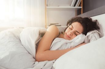 A woman sleeping on her side.
