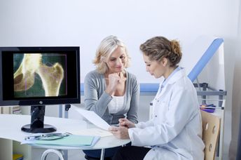 A doctor and patient looking at x-rays.