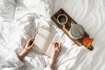 A person journals during the daytime.