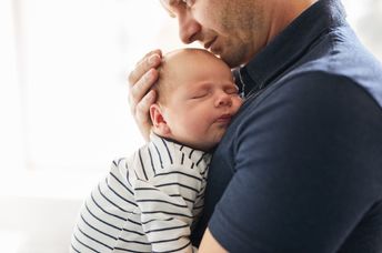 Father holding his newborn.