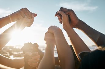 A group of people holding hands.