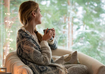 Woman keeping warm in the winter with a warm shawl.