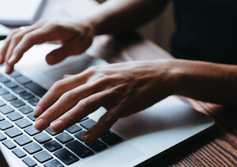A woman typing.
