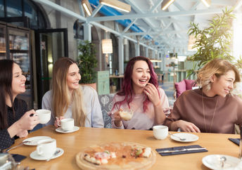 Female friends enjoying themselves in a cafe.