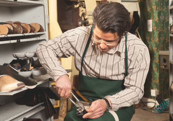 Shoemaker at work.