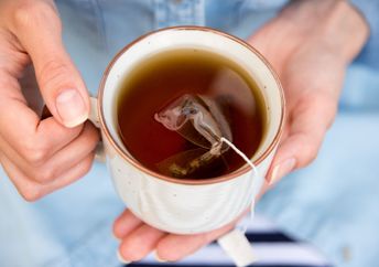 Enjoying a cup of hot tea.