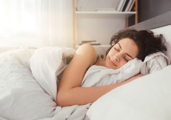 A woman sleeping on her side.