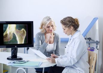 A doctor and patient looking at x-rays.