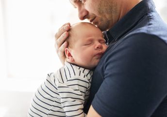 Father holding his newborn.