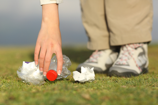 A person picking up litter. A person picking up litter.