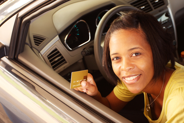 A woman pays with a credit card A woman pays with a credit card