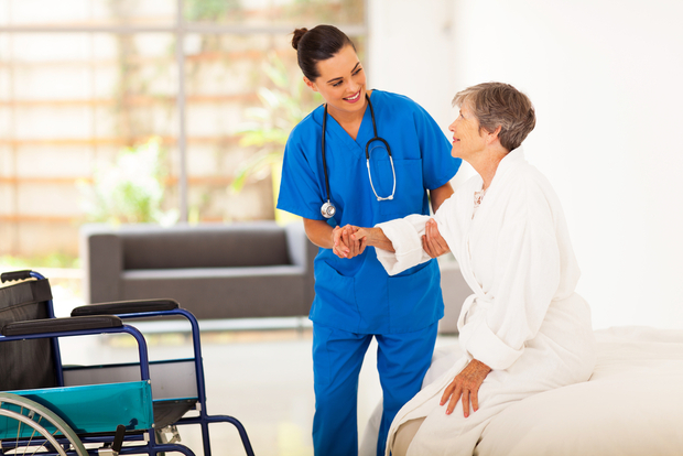 A nurse helps a patient A nurse helps a patient