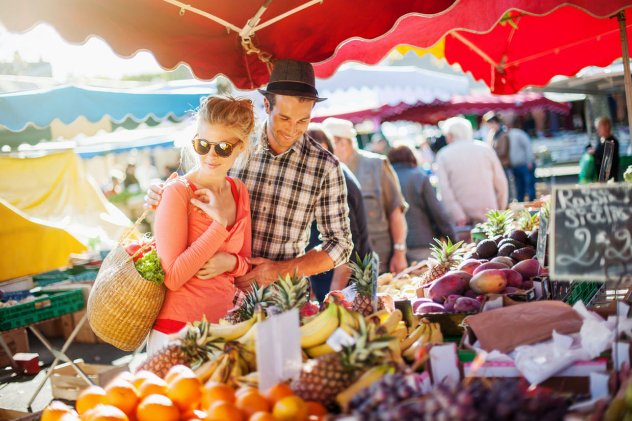 Couple looking at fruits in farmer's market Couple looking at fruits in farmer's market