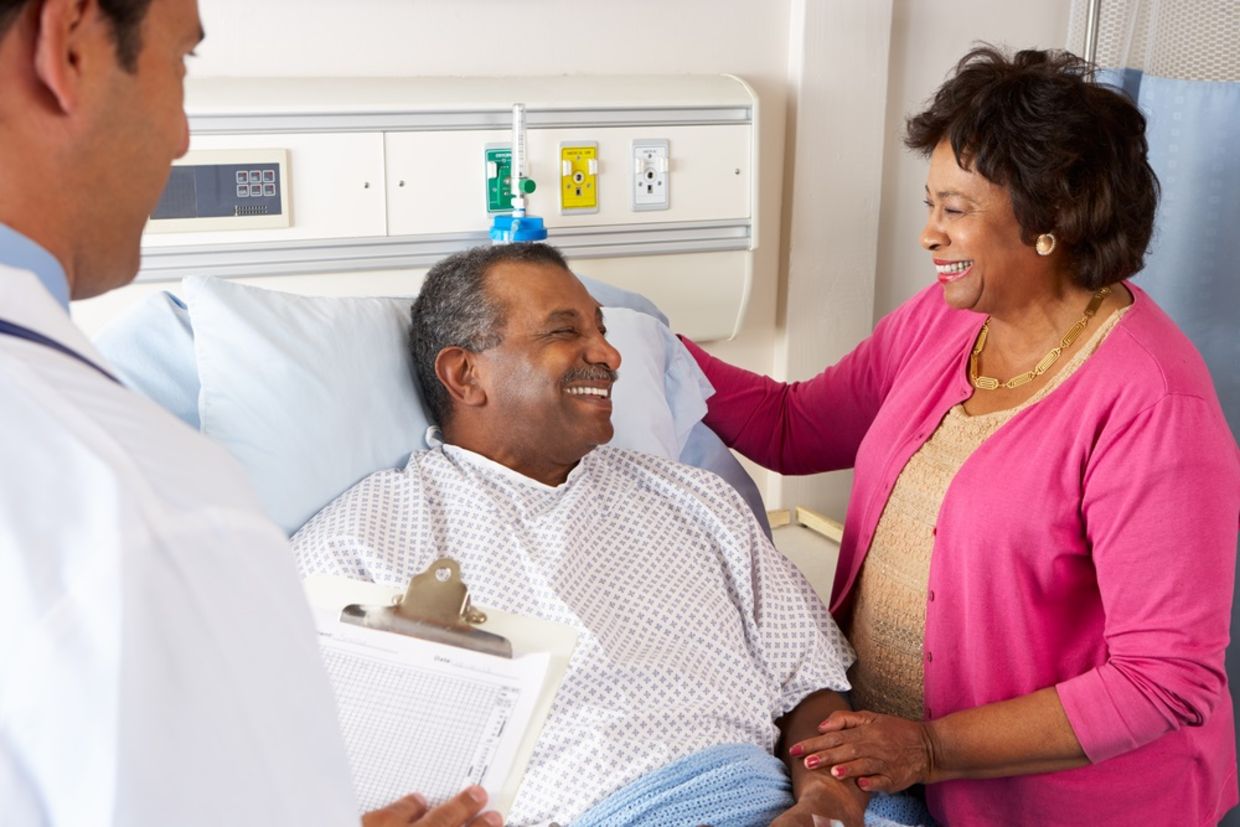 Doctor Talking To Senior Couple On Ward Doctor Talking To Senior Couple On Ward