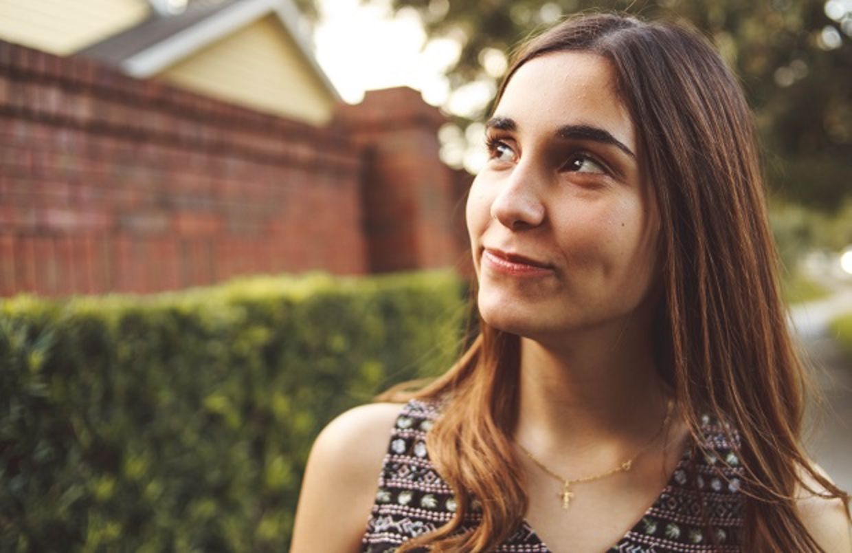 Young woman looking optimistically into the distance Young woman looking optimistically into the distance