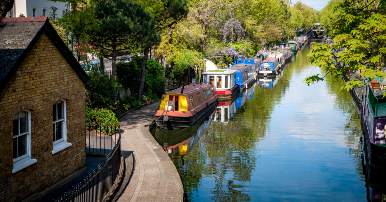 Rows of houseboats and narrow boats on the canal banks at Regent's Canal next to Paddington in Little Venice, London Rows of houseboats and narrow boats on the canal banks at Regent's Canal next to Paddington in Little Venice, London