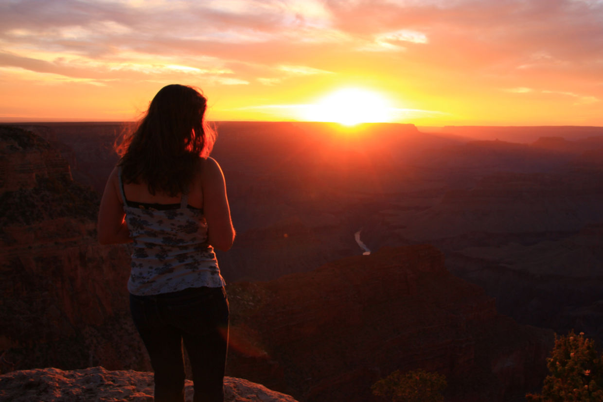 A woman looking in awe at a beautiful sunset A woman looking in awe at a beautiful sunset