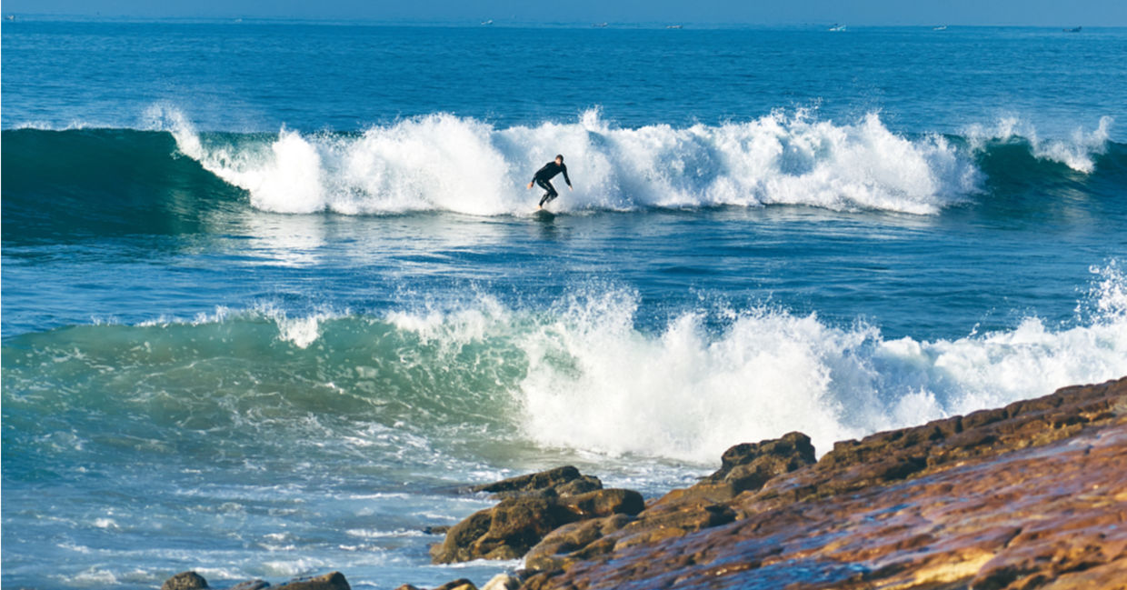 Young man surfing at Dracula's, Morocco Young man surfing at Dracula's, Morocco