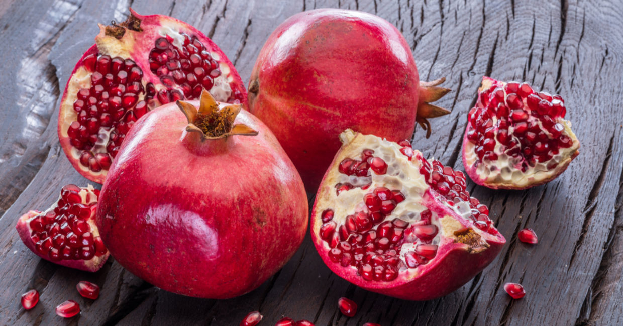 Ripe pomegranate fruit on wooden vintage background. Ripe pomegranate fruit on wooden vintage background.
