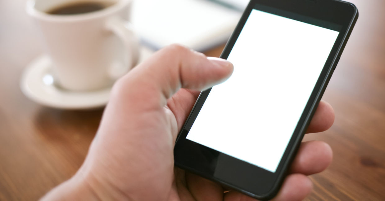A person holding using a smartphone with one hand A person holding using a smartphone with one hand