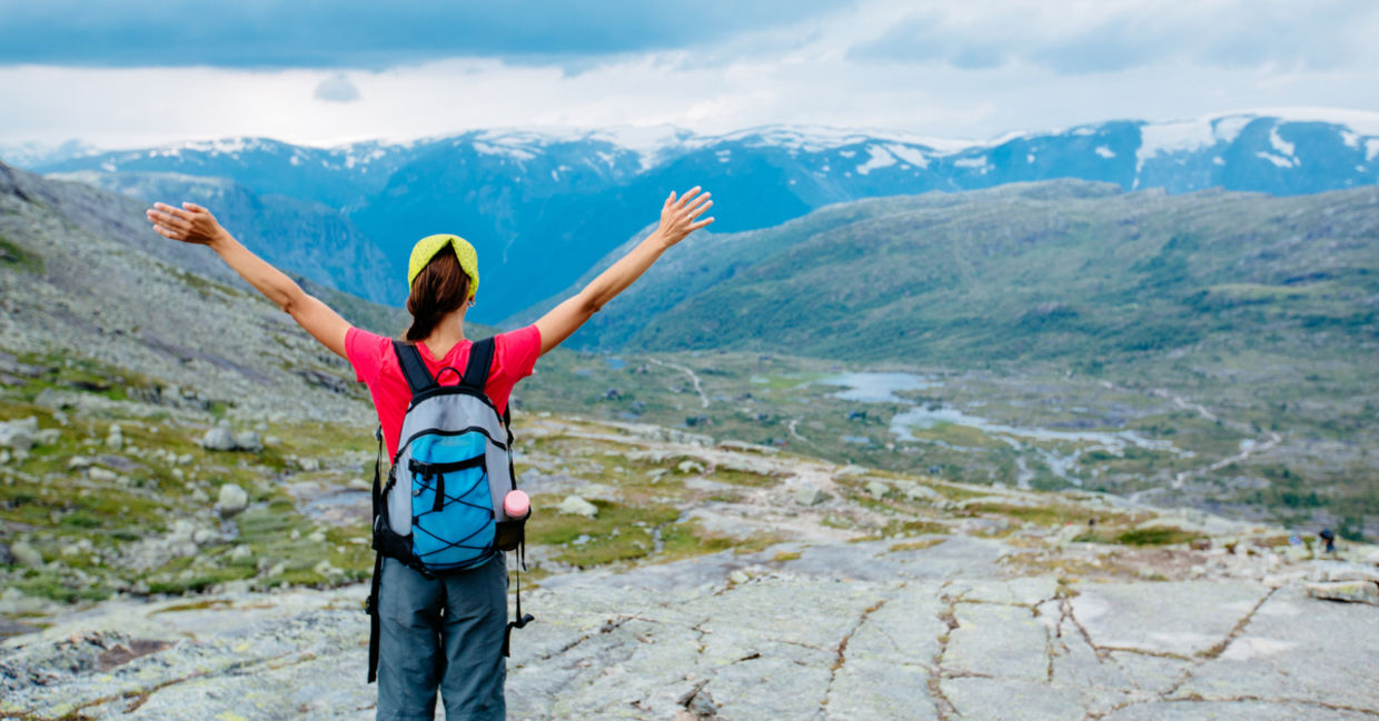 Woman stretching arms hiking Woman stretching arms hiking