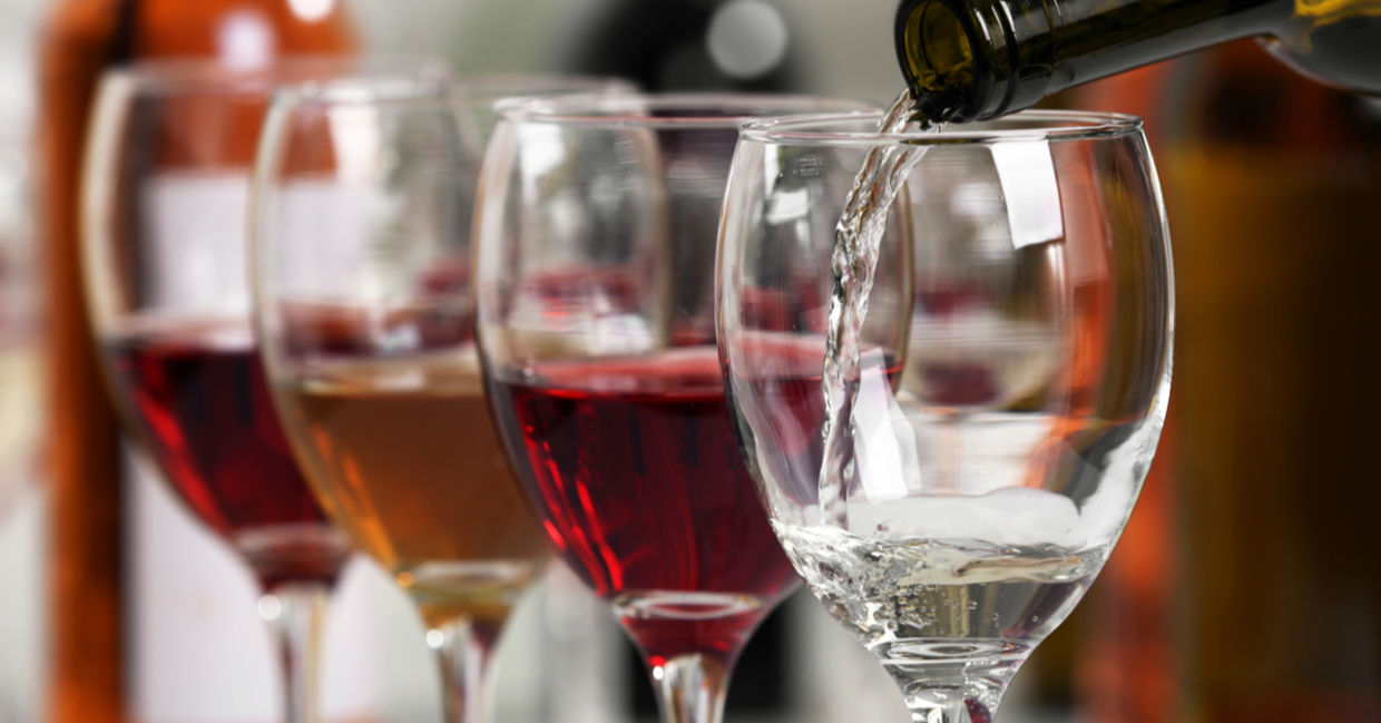 Wine being poured into wine glasses Wine being poured into wine glasses