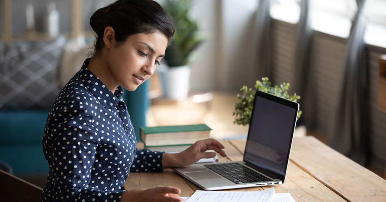woman concentrating at decluttered desk woman concentrating at decluttered desk