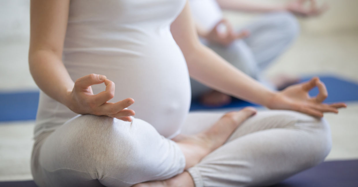 A pregnant woman meditating A pregnant woman meditating