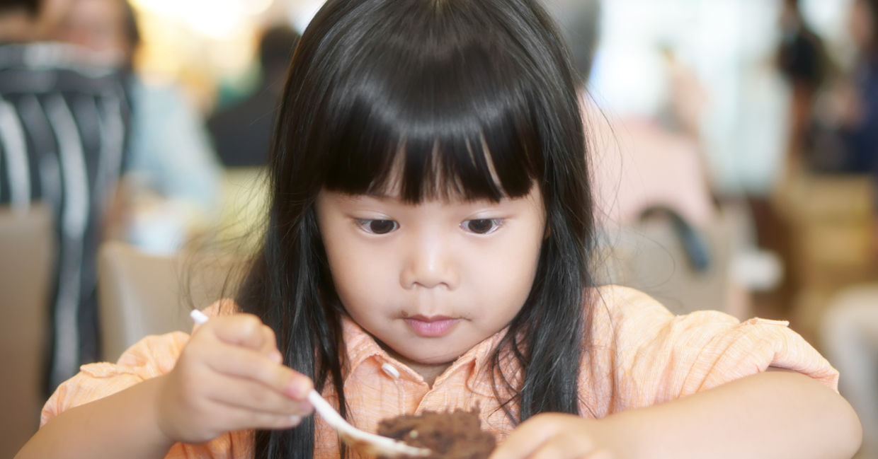 Young girl enjoying cake Young girl enjoying cake