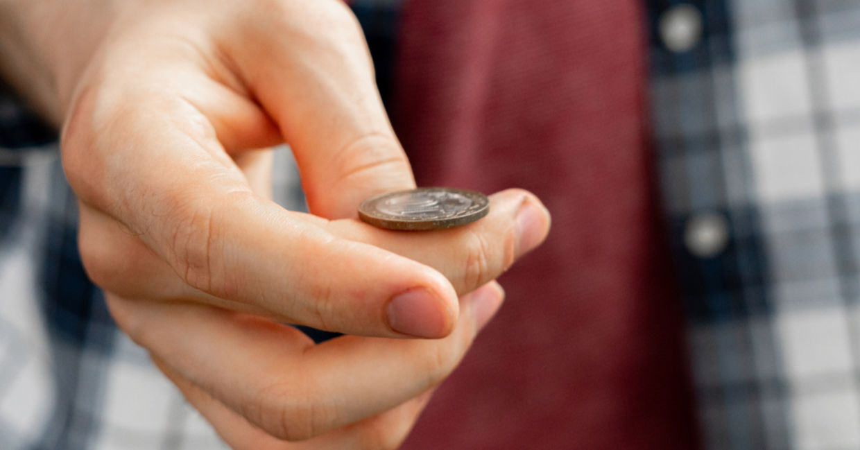 A man flips a coin, connecting with his sixth sense. A man flips a coin, connecting with his sixth sense.