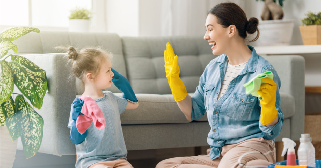 Mom and daughter having fun cleaning the house Mom and daughter having fun cleaning the house