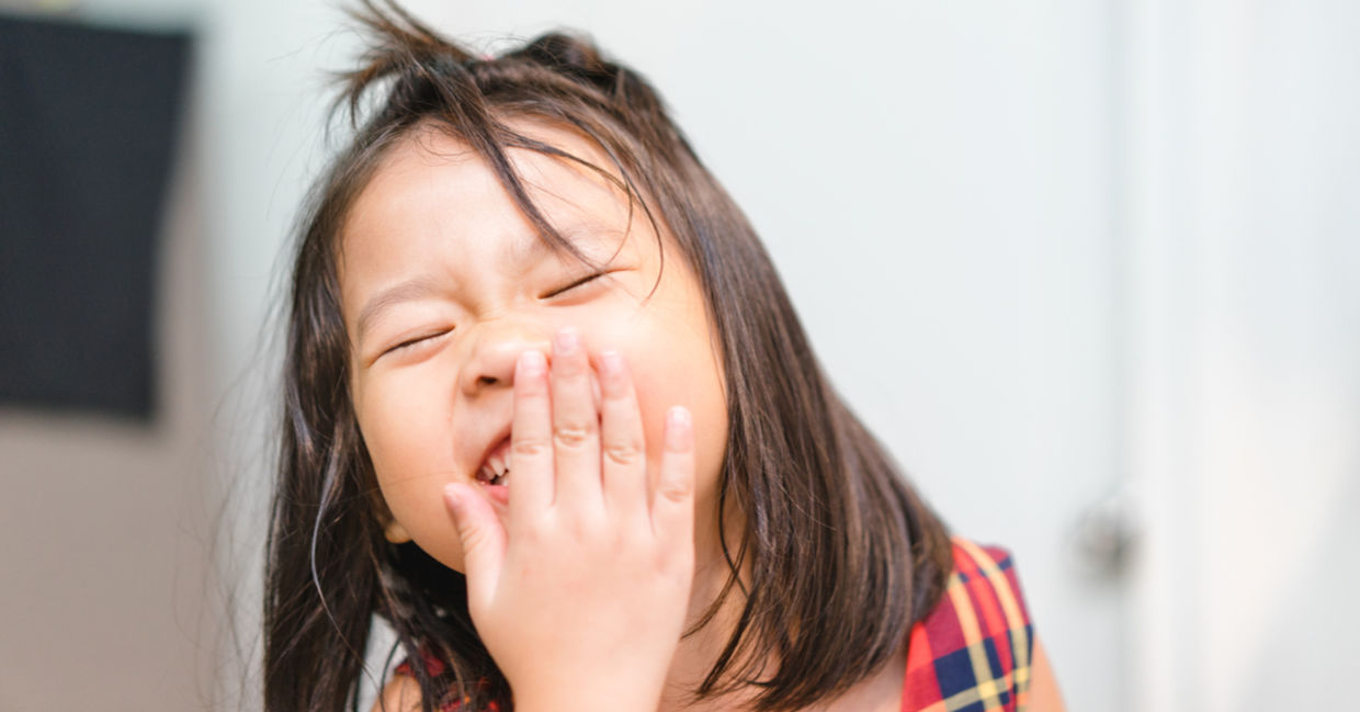 A little girl laughs with happiness. A little girl laughs with happiness.