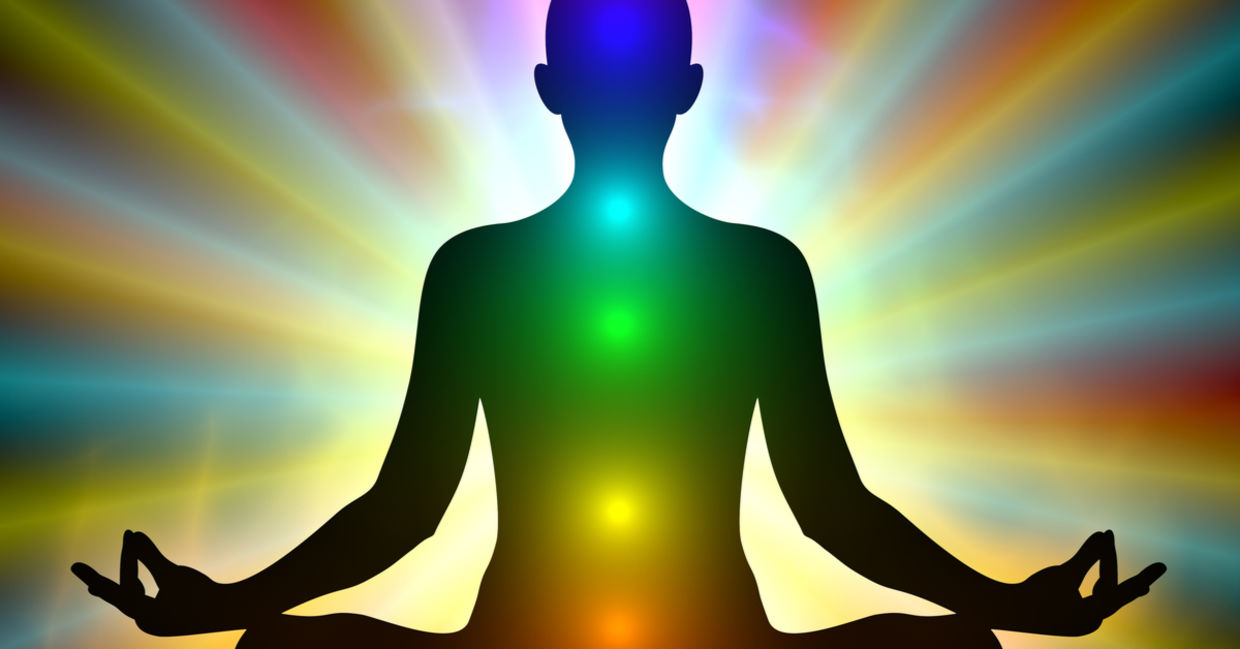 Aura colors and glowing chakras on a man who is meditating. Aura colors and glowing chakras on a man who is meditating.