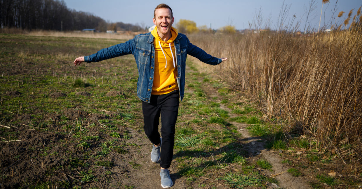 Smiling man feels elevated and free as he enjoys the simple life walking in nature. Smiling man feels elevated and free as he enjoys the simple life walking in nature.