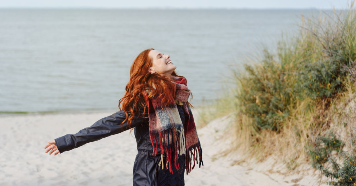 Joyful woman flings arms out Joyful woman flings arms out