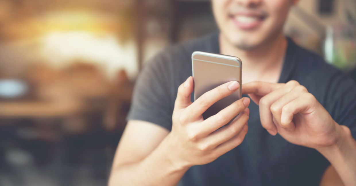 Man intrigued by his smartphone Man intrigued by his smartphone