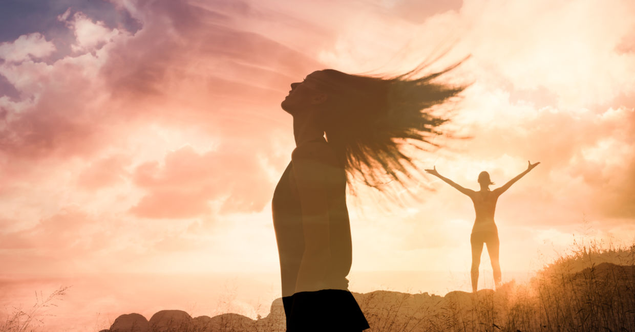 Woman triumphant at sunset Woman triumphant at sunset