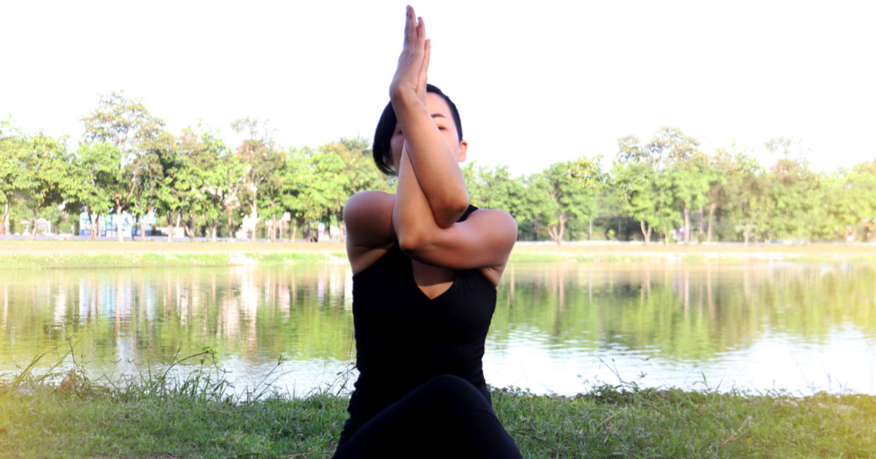 Woman in eagle yoga pose. Woman in eagle yoga pose.