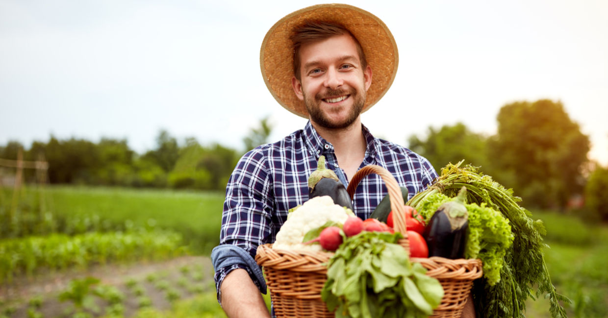 Young farmer holding crops Young farmer holding crops