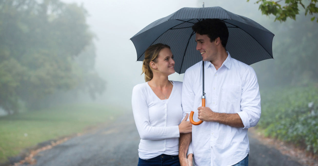 A happy couple under an umbrella A happy couple under an umbrella