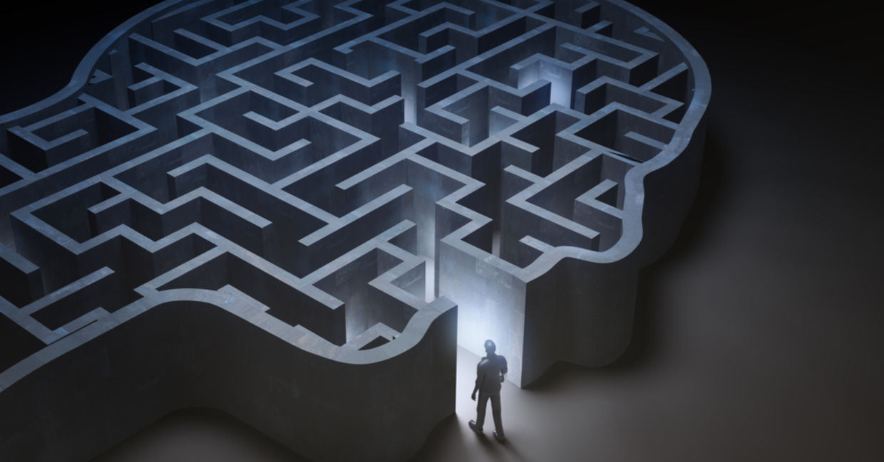 A dreamy image of a man entering a maze that is in the shape of a human head. A dreamy image of a man entering a maze that is in the shape of a human head.