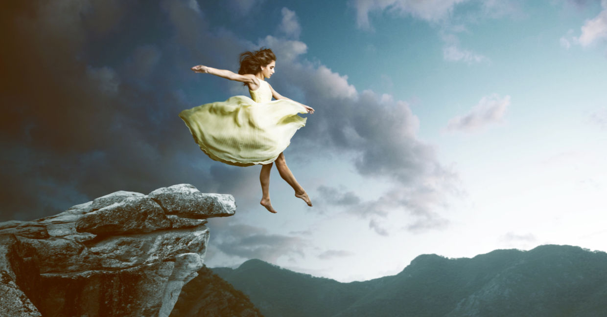 Dreamy image of a woman in a billowy dress floating off a high cliff. Dreamy image of a woman in a billowy dress floating off a high cliff.