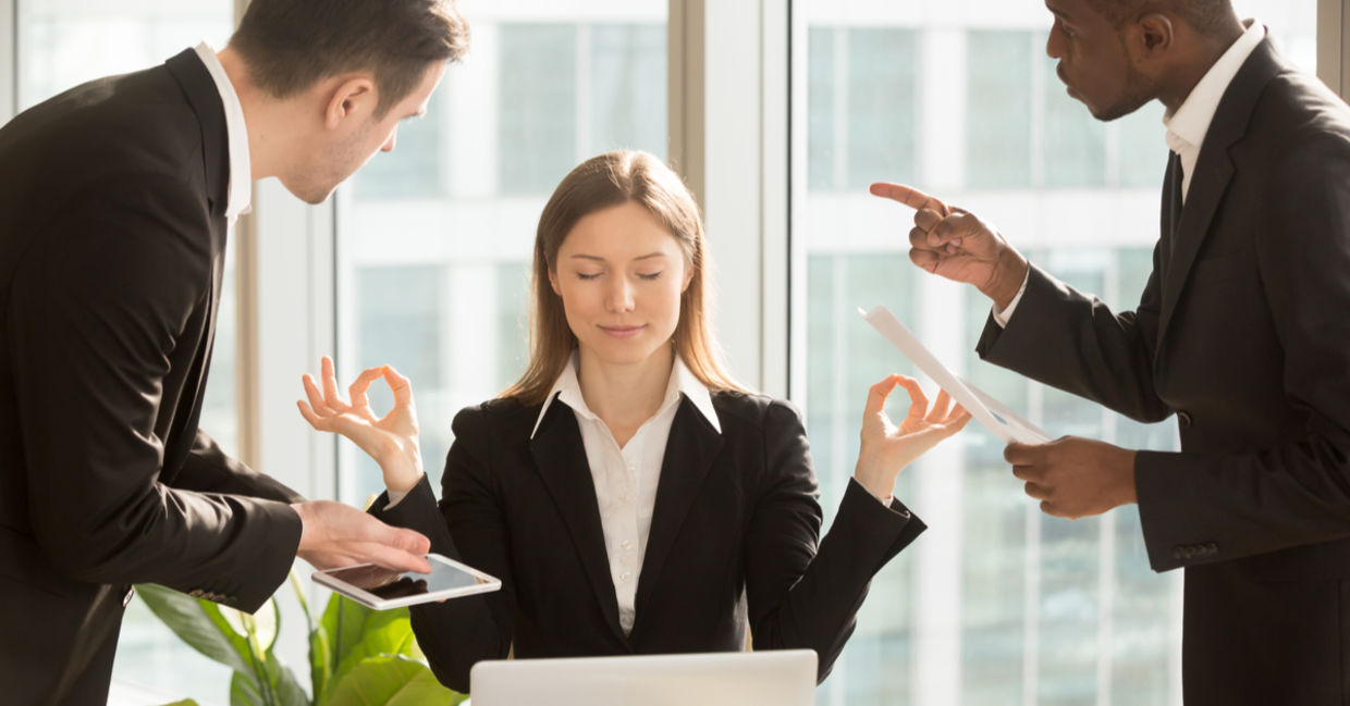 A businesswoman faced with conflict and pressure practices patience in the form of meditation. A businesswoman faced with conflict and pressure practices patience in the form of meditation.